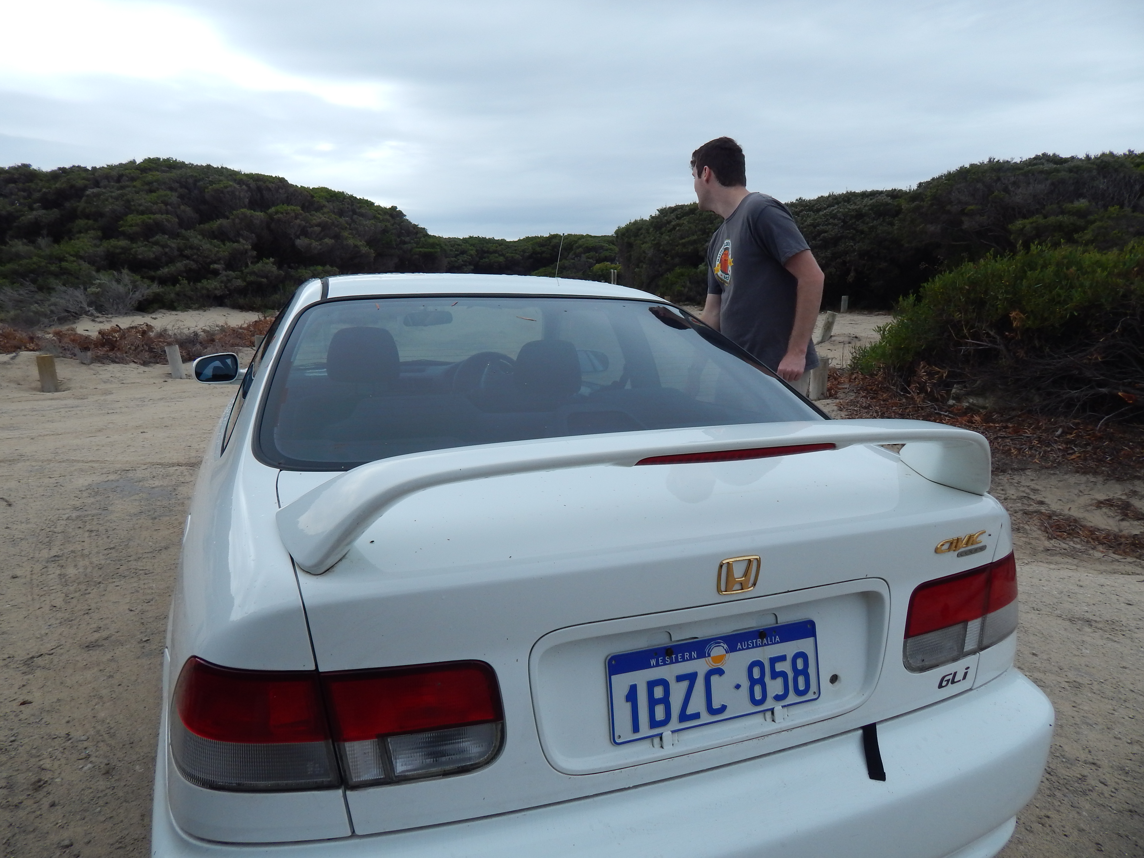 Car on a camp-site somewhere, with a much younger me getting out of it. I have no idea where or by whom it was taken, but it's an accurate depiction of the vibe. 