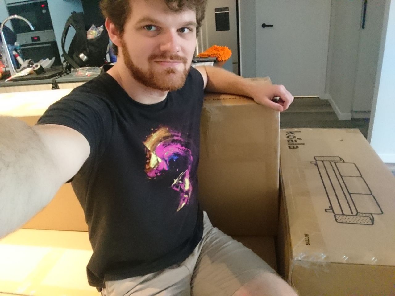 sitting on my delivered couch boxes as if they are a couch
