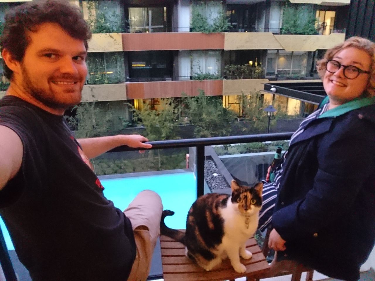rocky, grace and harriet (the cat) on a balcony on a cold, locked-down may evening